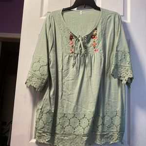 Sage green with flowers that are embroidered with crochet light linen